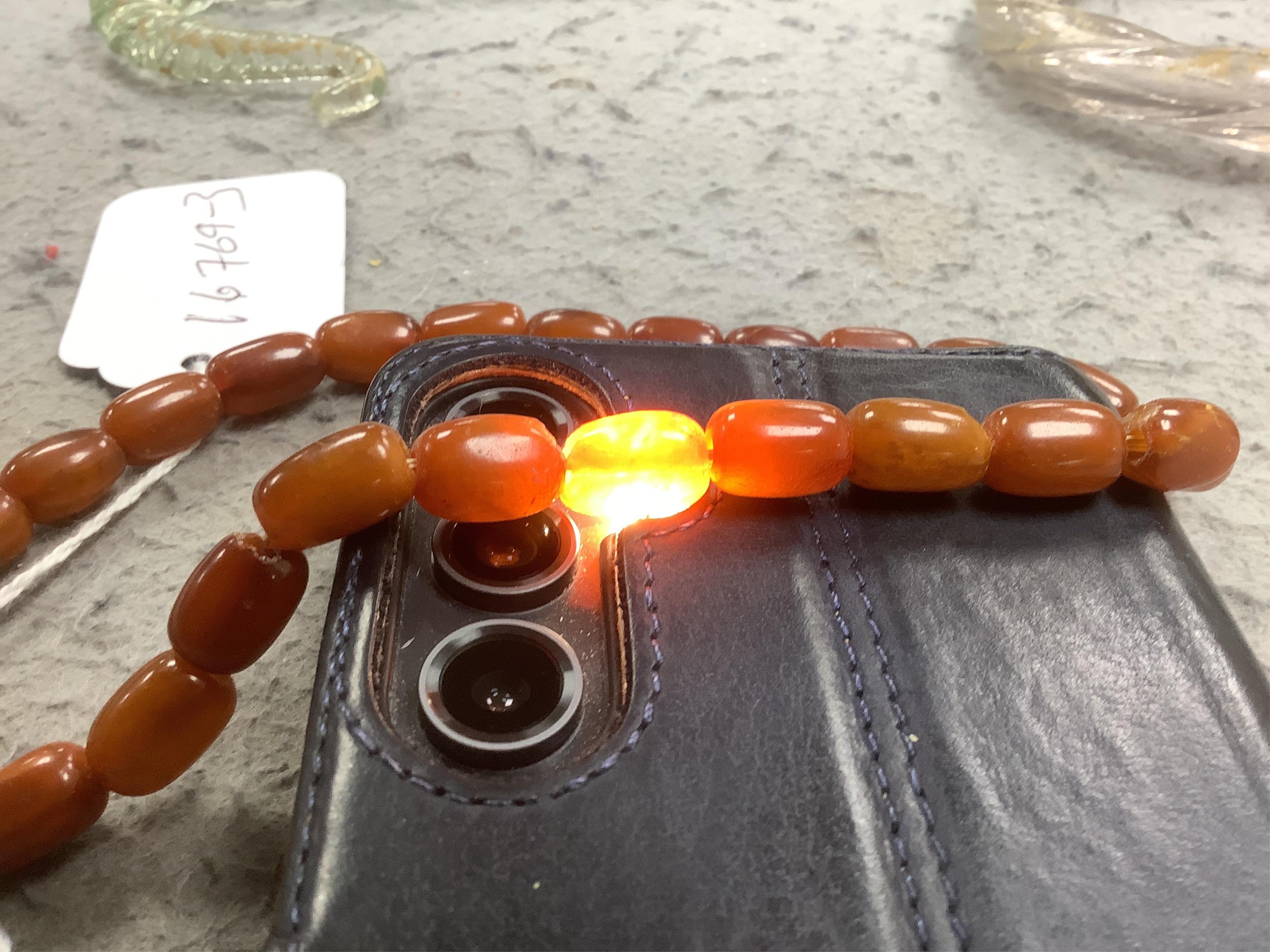 A single strand amber bead necklace, 34cm, gross weight 20 grams. Condition - poor to fair